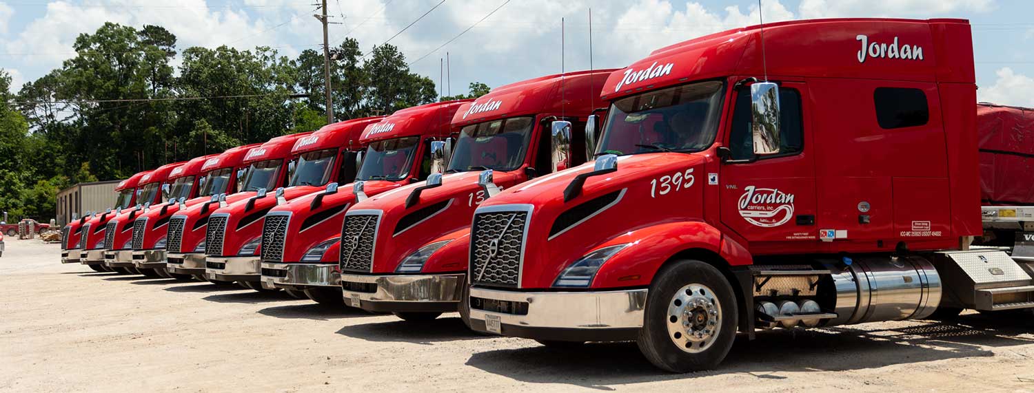 Group of red trucks in a yard